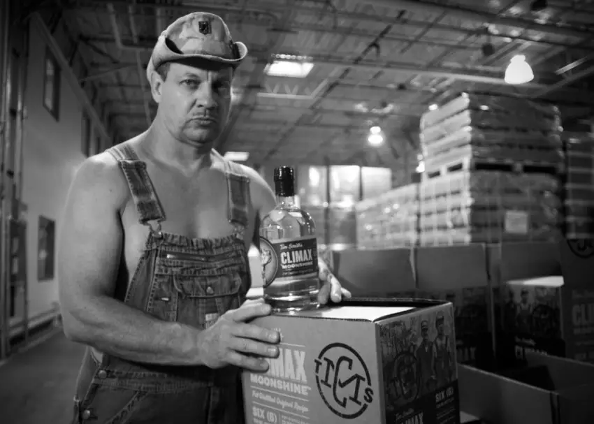Tim Smith with Bottle of Climax Moonshine Original Recipe